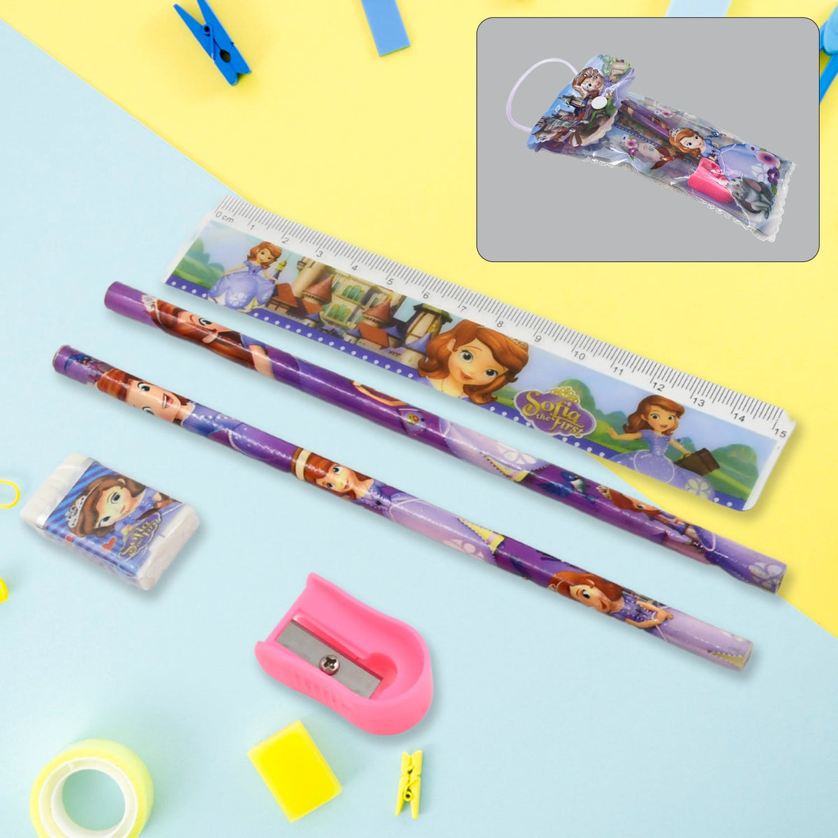 A cartoon-themed stationery set with two pencils, a ruler, an eraser, and a pink sharpener on a blue and yellow