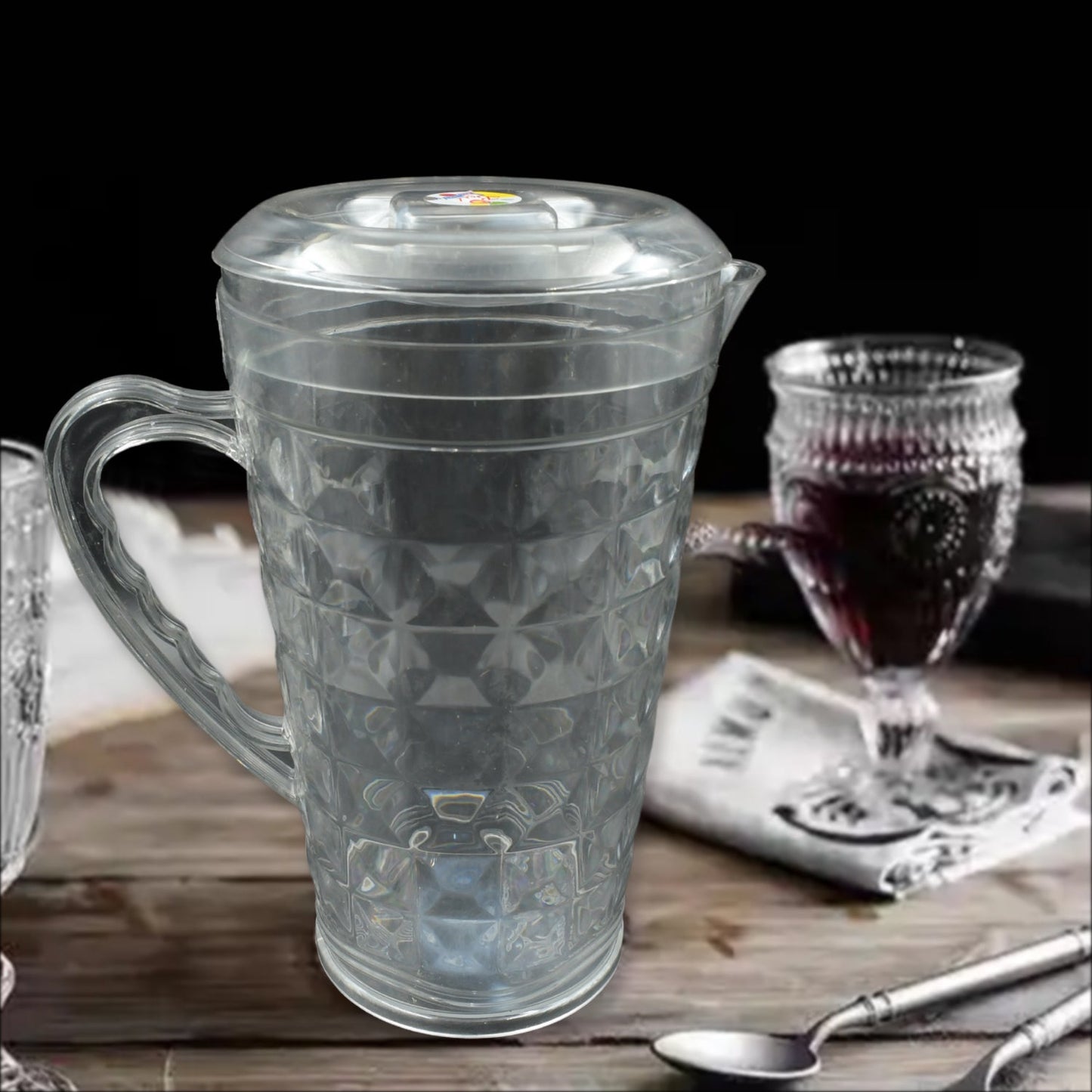 Angled view of the Mocktail PET Plastic Jug, highlighting its elegant diamond-cut design and clear material.