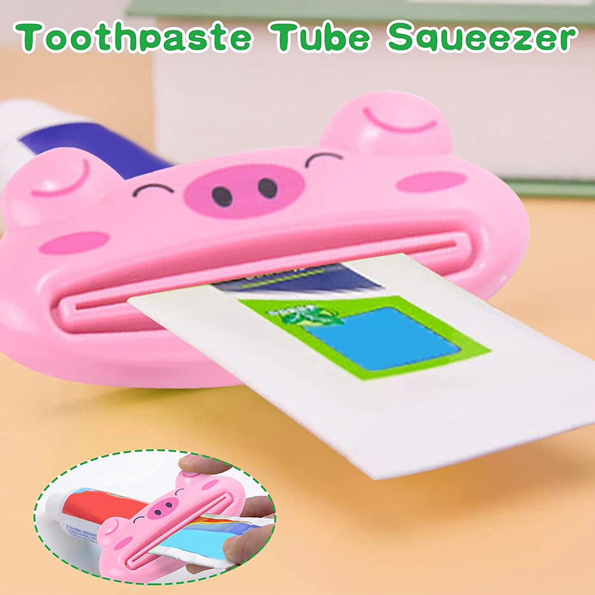 A close-up of a pink pig-shaped toothpaste squeezer with a partially inserted tube, with an inset image showing how to use
