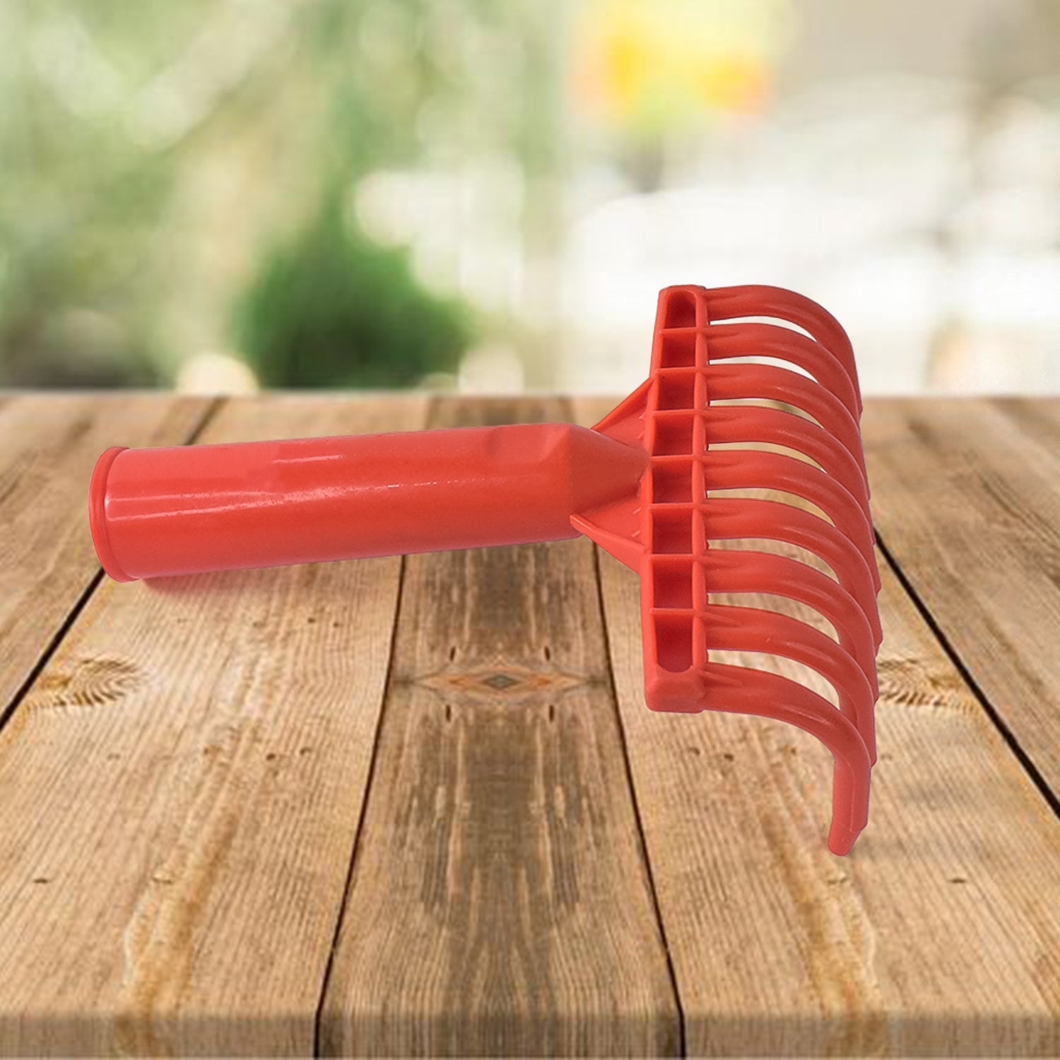 Durable plastic hand rake with ergonomic grip for soil and leaf clearing