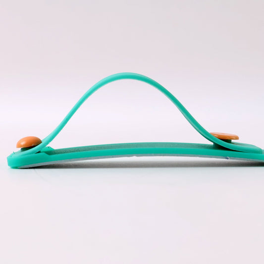 Phone grip strap in teal green used as a kickstand