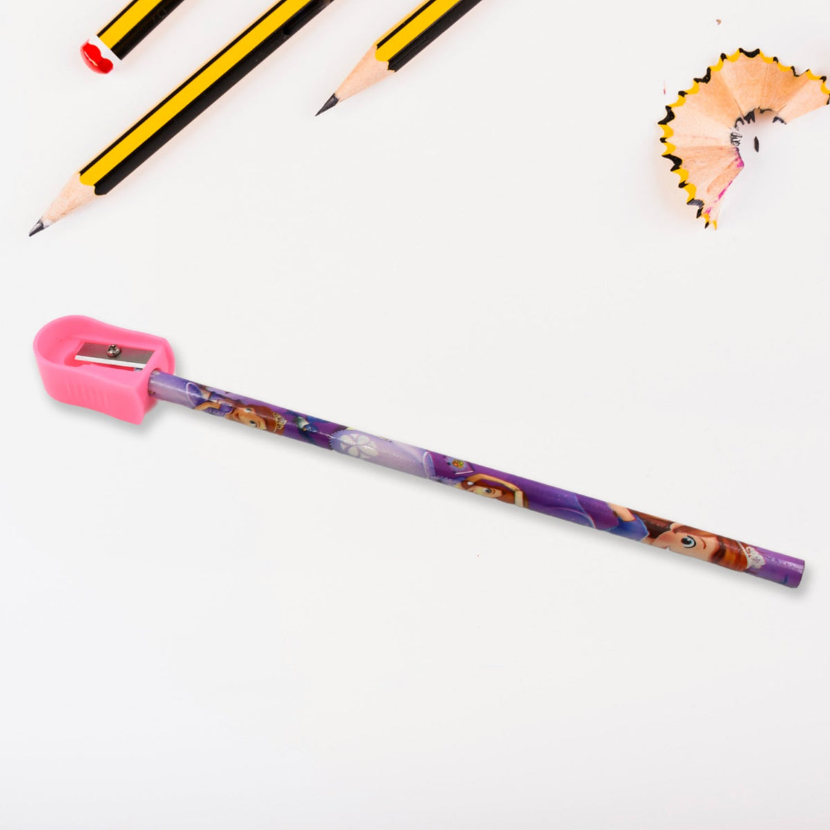 A purple pencil being sharpened by a pink sharpener, with pencil shavings and other pencils in the