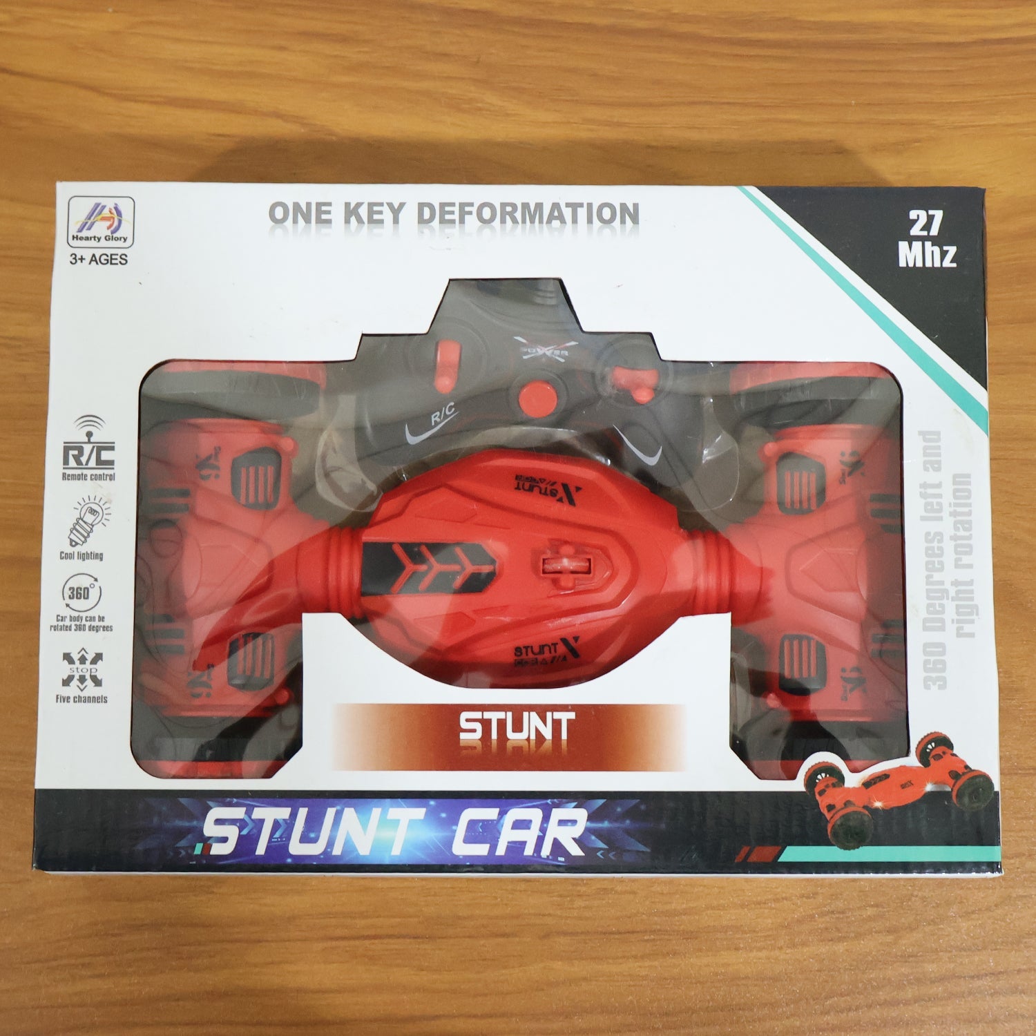 Wireless remote control placed beside stunt car toy