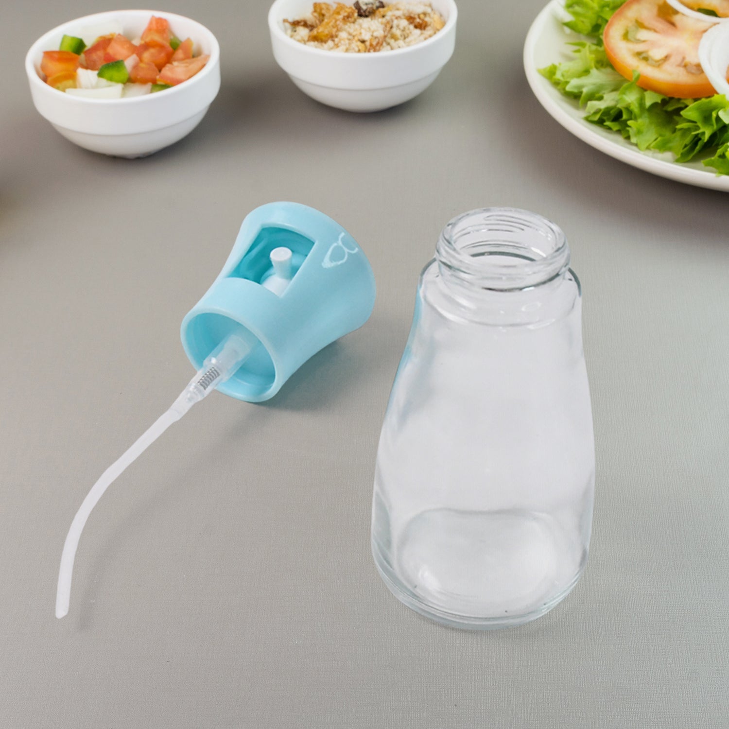 The 170ml oil dispenser bottle complete with its protective cap and fine mist nozzle.