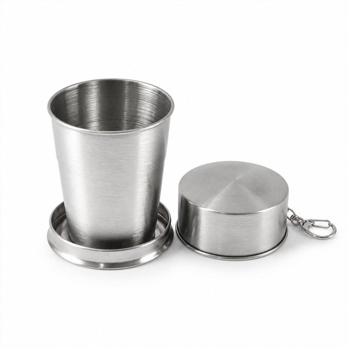An expanded stainless steel collapsible cup and its closed case with a keychain are displayed on a plain white background.