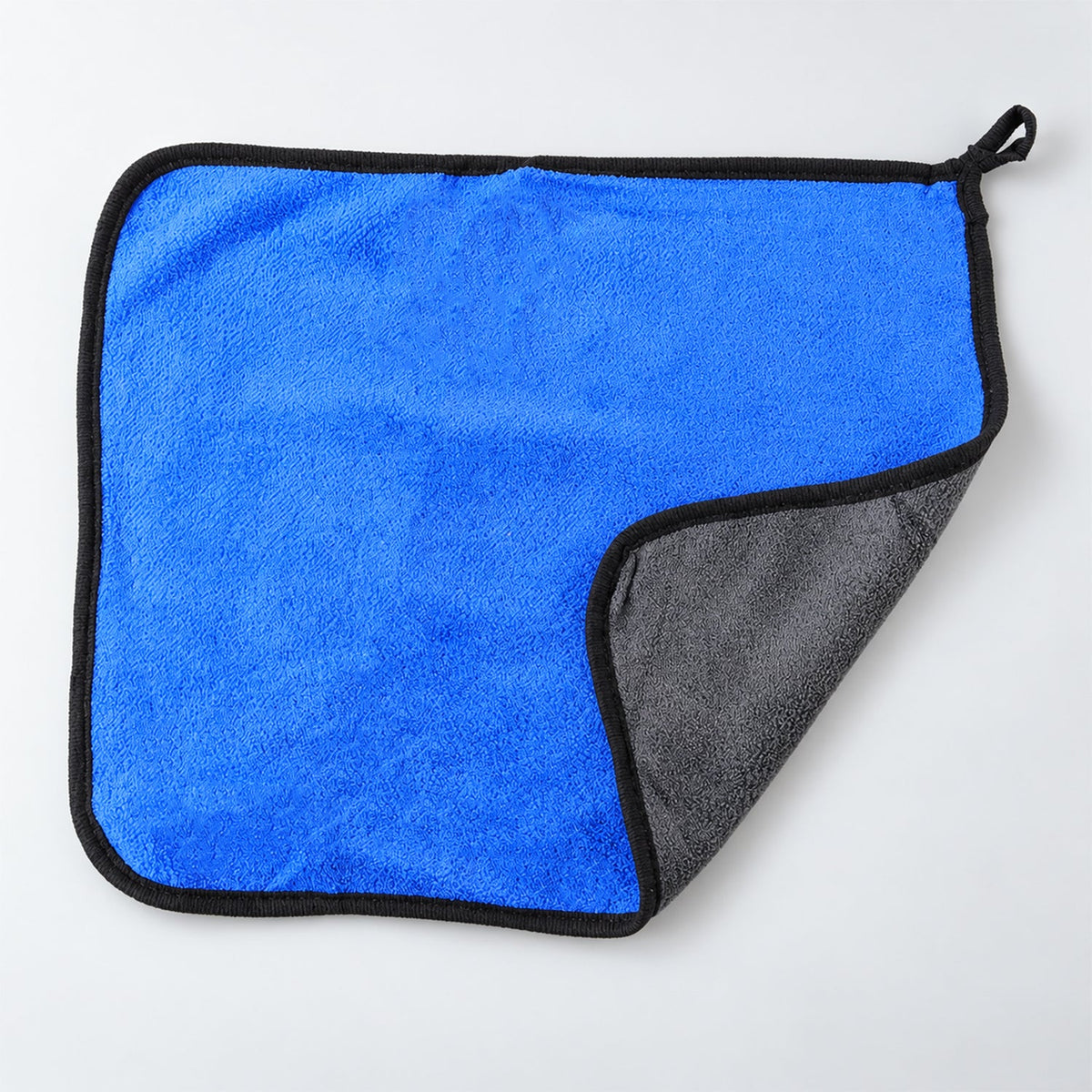 A blue microfiber cleaning cloth with a black border, folded to show its gray underside.