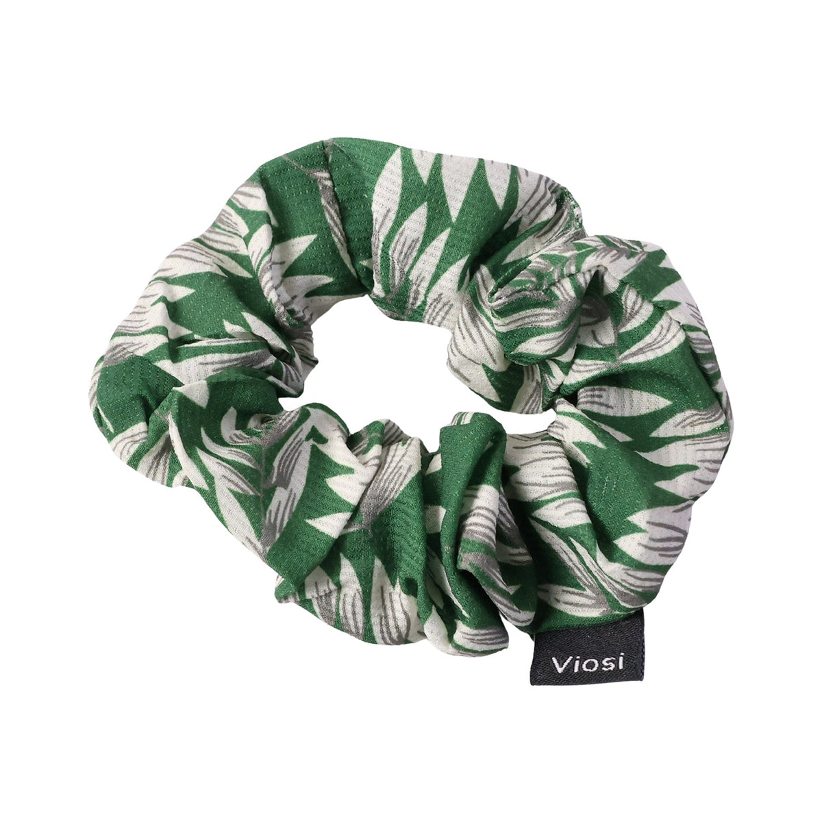 A green and white leaf print scrunchie with a black 'viosi' tag is shown against a plain white background.