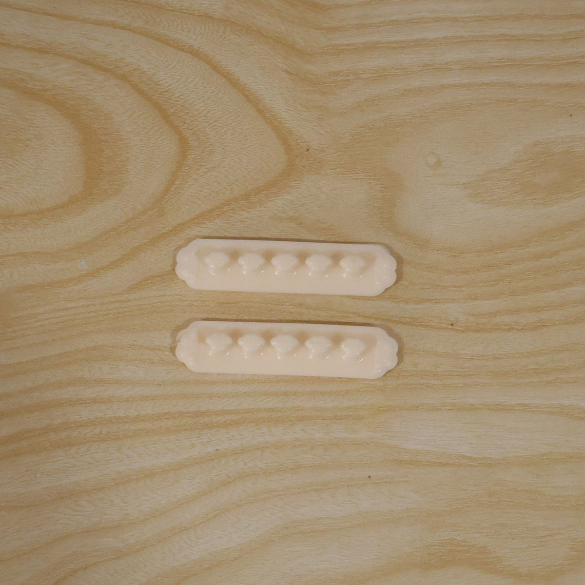 Pack of two self adhesive plastic wire cable organizer clips in their retail packaging.