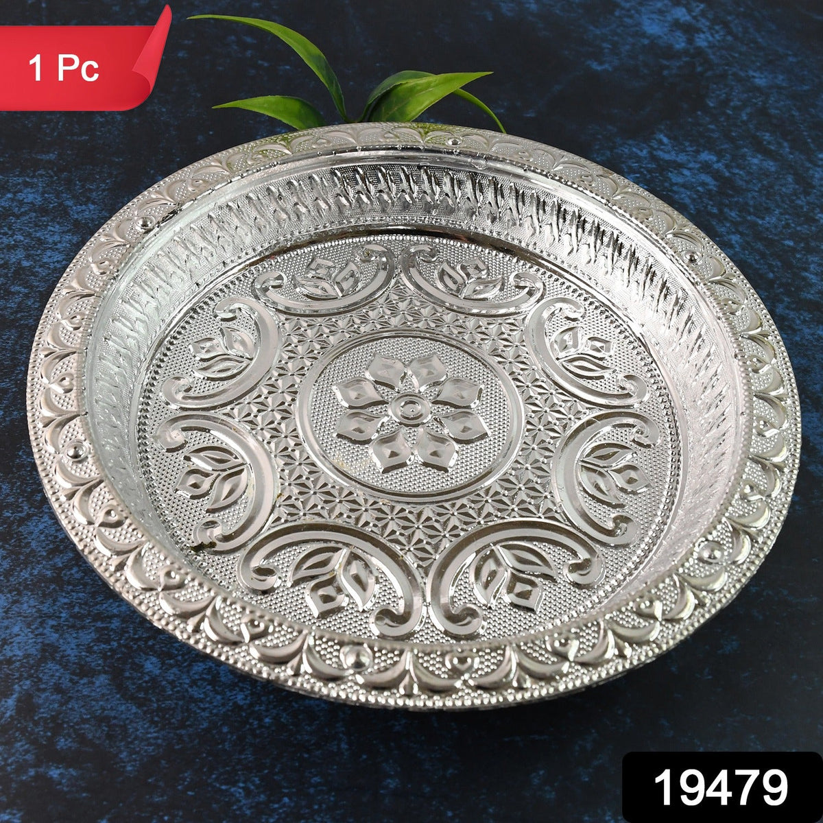 A round silver-colored plastic pooja thali with intricate embossed floral and geometric patterns, with a red "1 Pc" label.