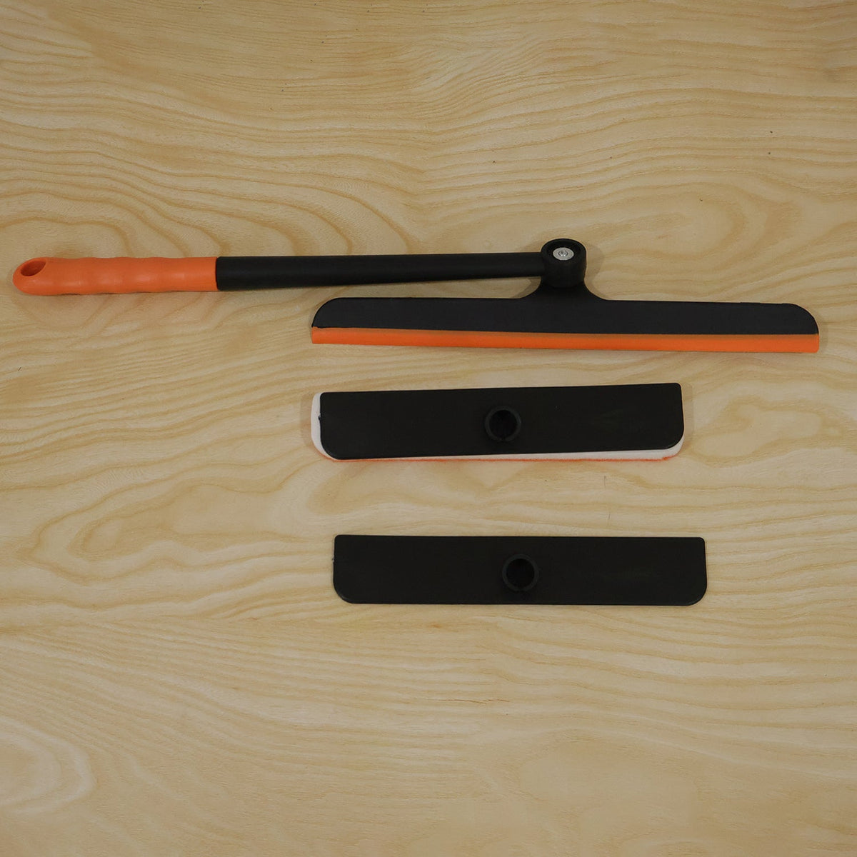 Live product photo of the orange and black window squeegee in a home setting