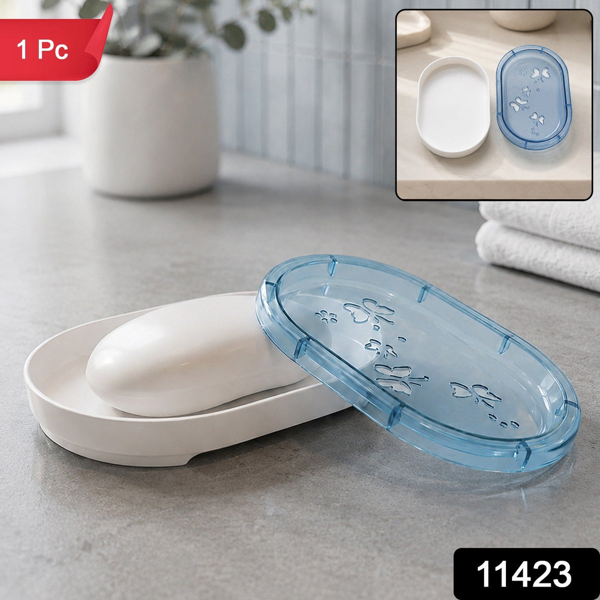White soap dish with a bar of white soap and a translucent blue lid with butterfly cutouts, in a bathroom setting.