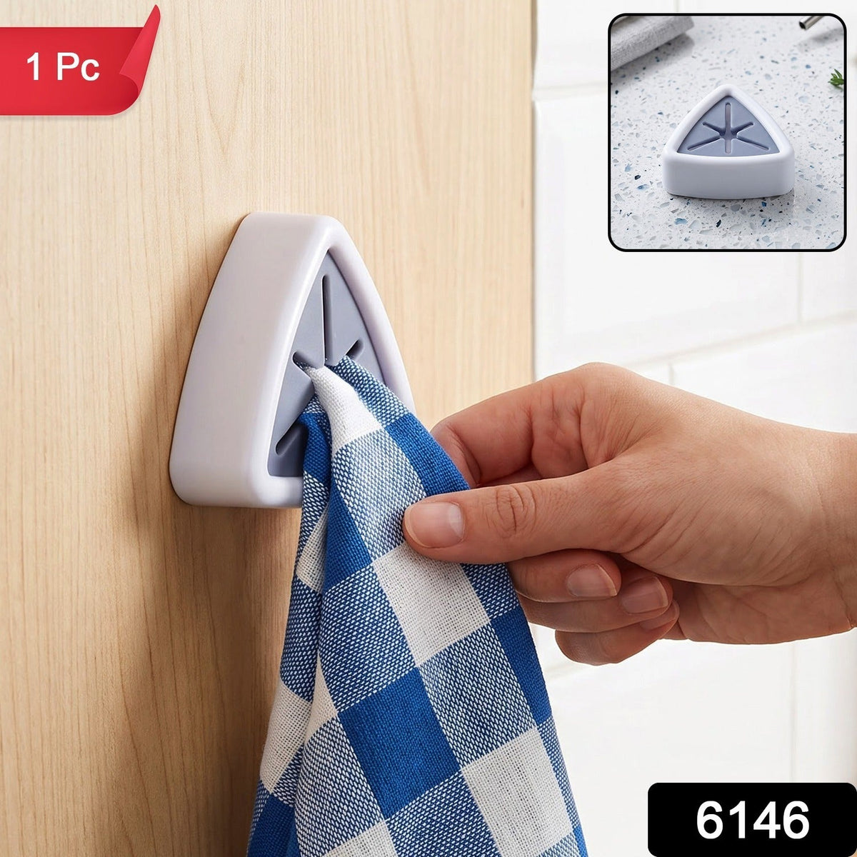 A hand inserts a blue and white checkered towel into a white and grey triangular wall-mounted towel holder on  light wooden