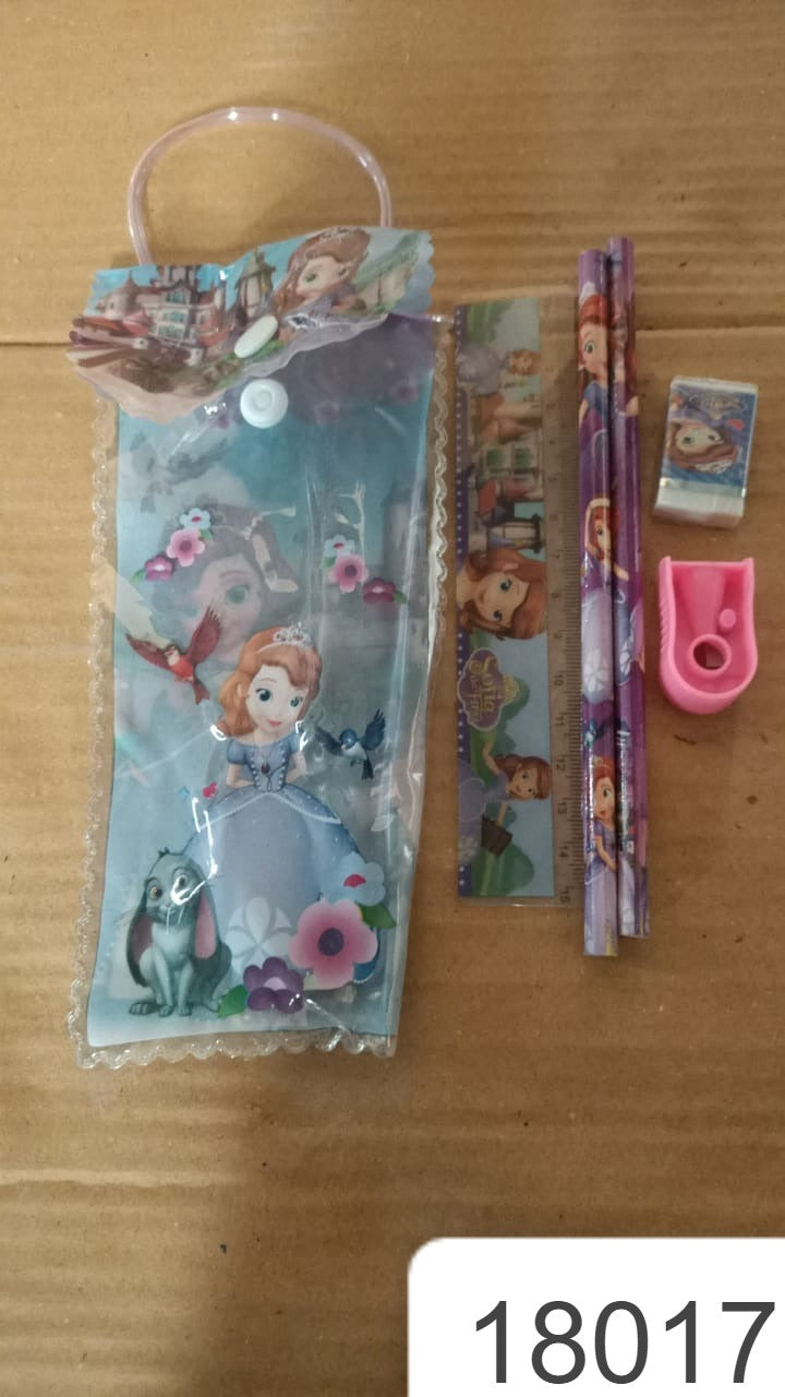 A cartoon-themed stationery set, including a clear pouch, pencils, ruler, eraser, and sharpener, on a brown surface.