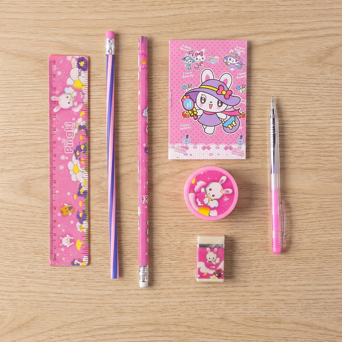 A pink rabbit-themed stationery set, including a ruler, notebook, two pencils, a pen, a sharpener, and an eraser, – view 9