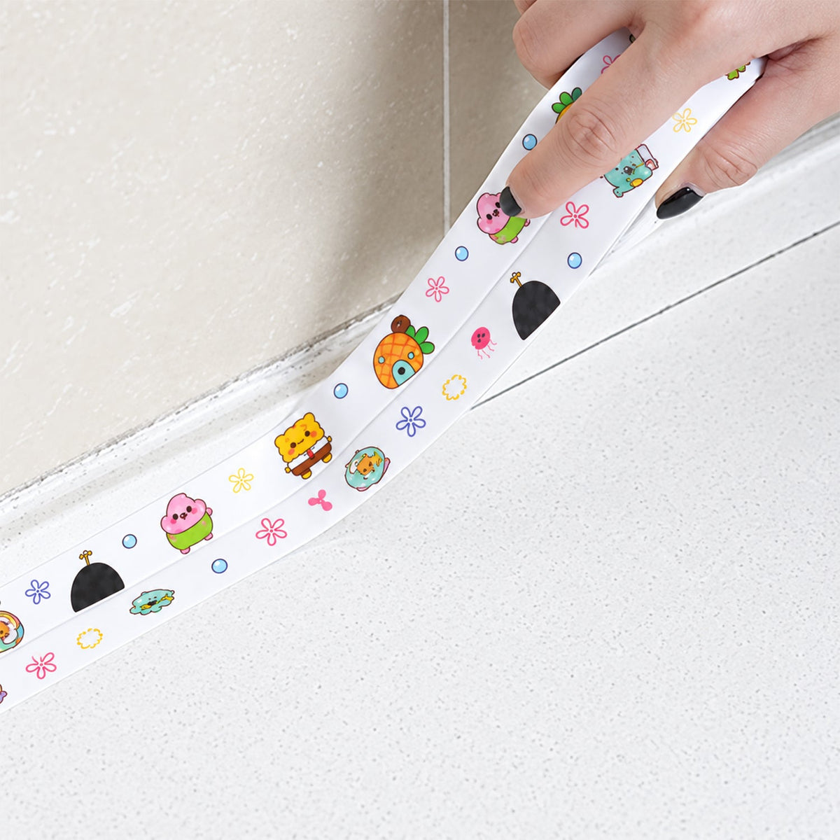 A hand applies the cartoon-printed sealing tape along a white tiled wall and counter edge.