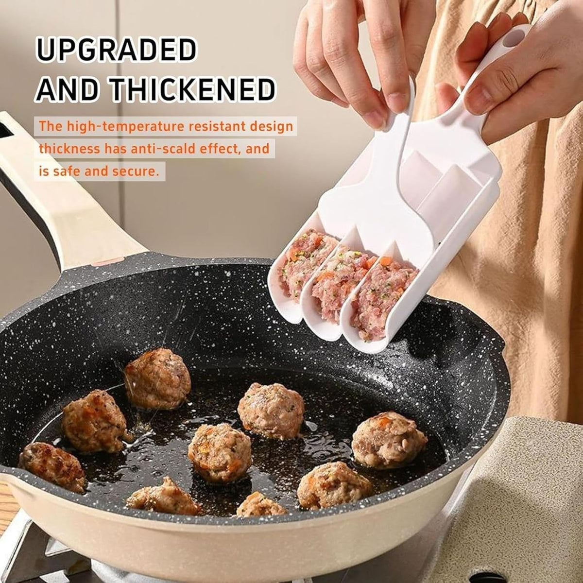 A person uses a white plastic meatball maker to scoop raw meatballs into a sizzling pan with cooked meatballs.