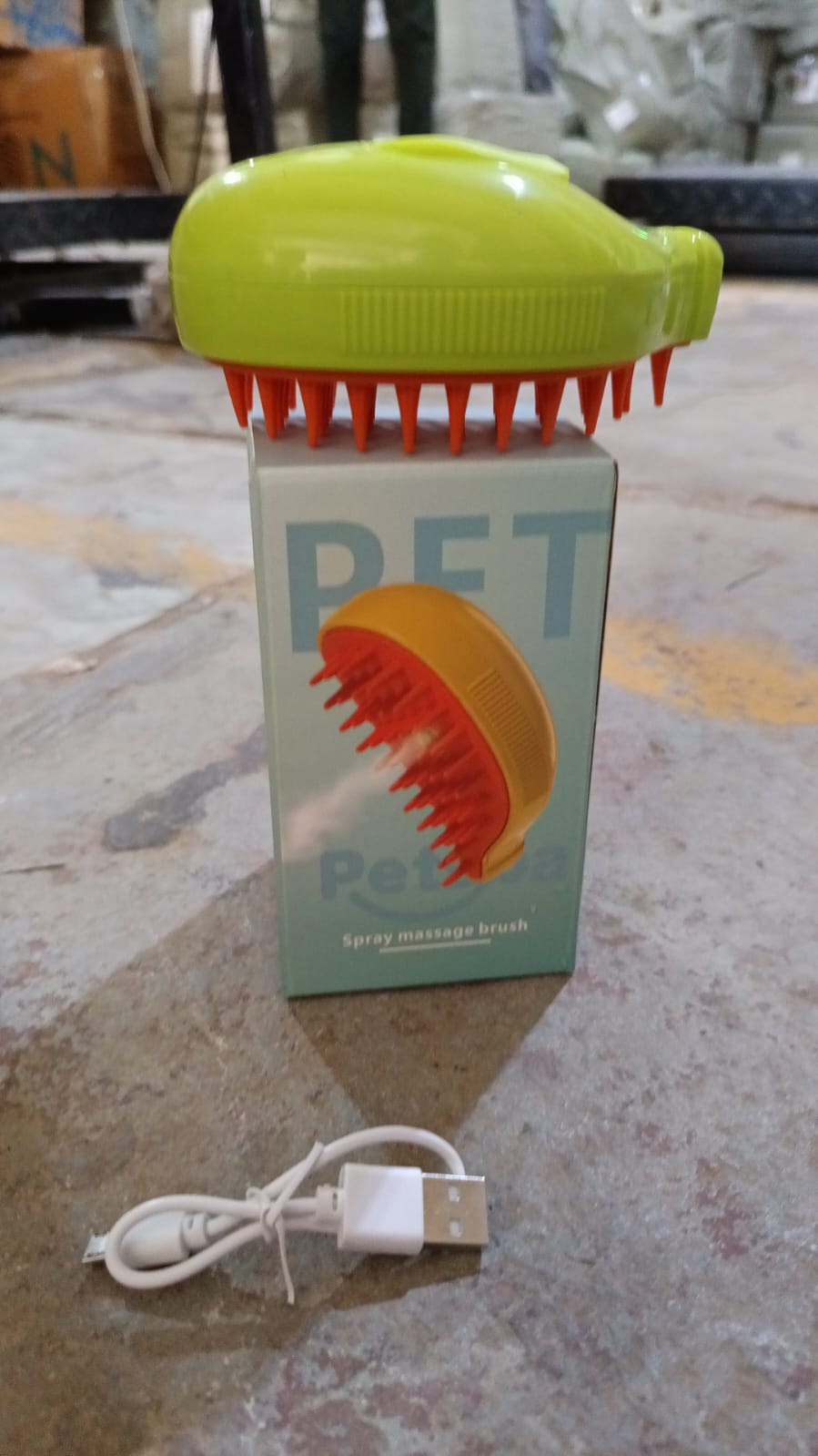 Removing loose fur from a pet with the lime green and orange pet grooming brush.